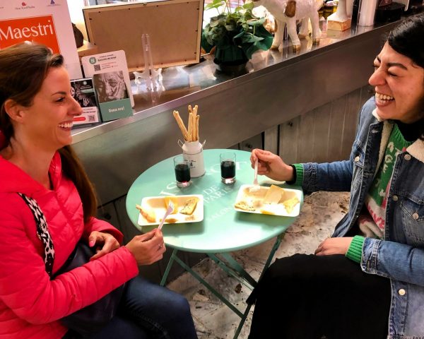 Group enjoying food tour in Turin streets